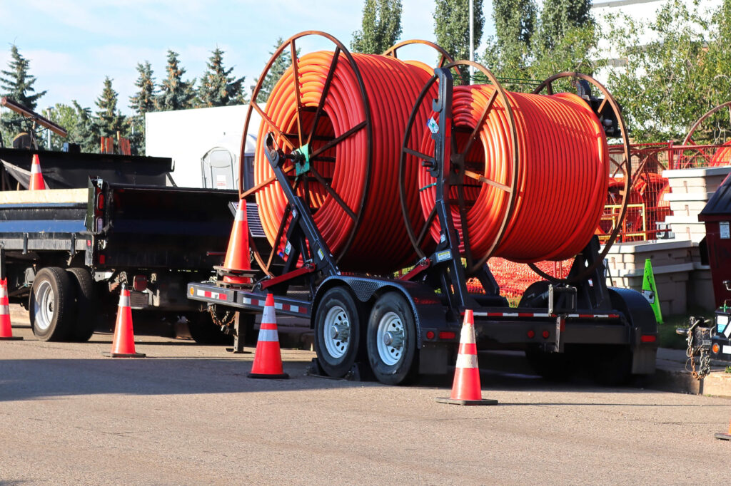 two large spools of fiber conduit on a trailer